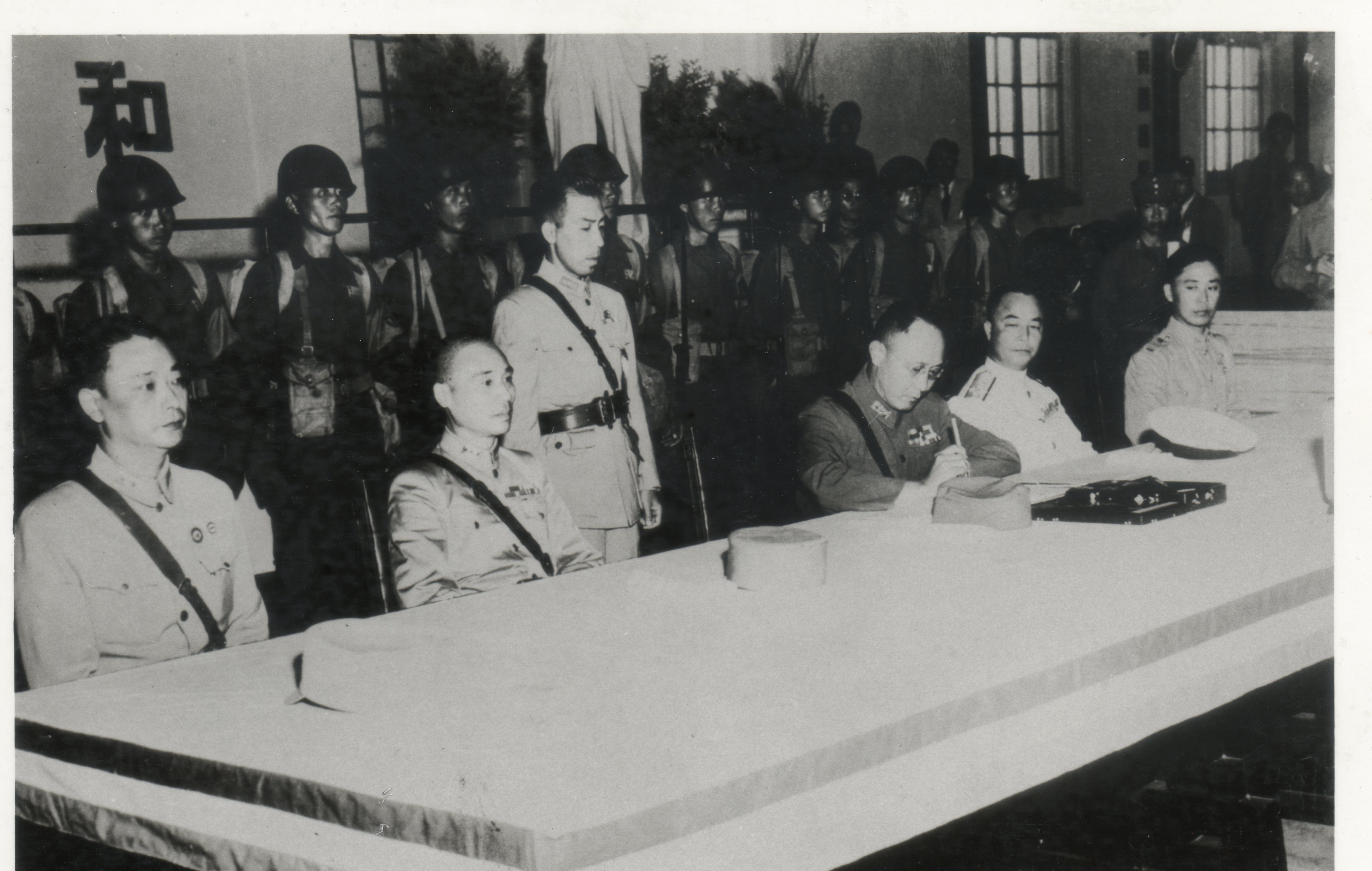 民國34年9月9日，日本投降典禮，中國陸軍總司令何應欽代表受降，在降書上簽字（日本代表為中國派遣軍總司令官岡村寧次大將)