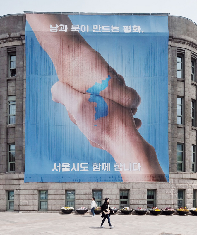 韓國文化體育觀光部9日公布的民調顯示，61.1%的受訪者認為南北韓統一「不急」。圖為2018年南北韓高峰會宣傳廣告。(圖：中央社)