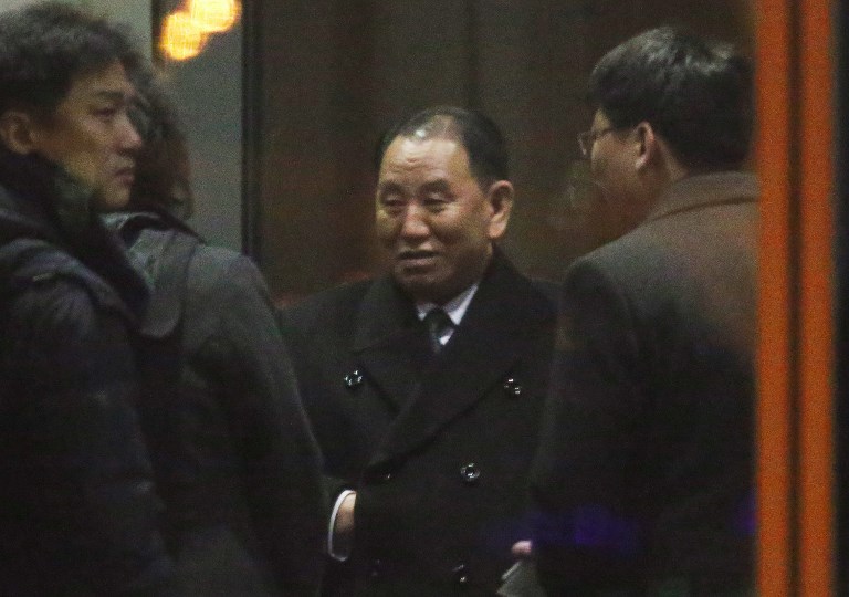 圖為在北京準備轉往美國的金英哲(中)。(資料照片/AFP)