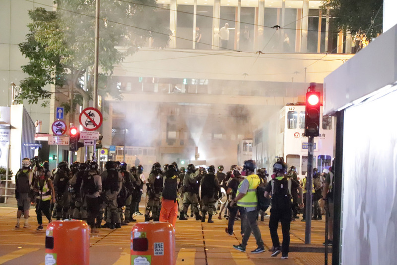 香港「反送中」網友趁著31日萬聖節之際發起集會遊行，許多人不顧禁蒙面法，戴著面具上街。圖為警方晚間10時左右在蘭桂芳附近發射催淚彈驅散示威者。(資料照片/中央社)