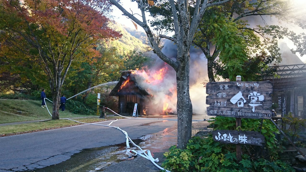 日本被登錄為世界遺產的合掌村木屋被熊熊烈焰包圍，冒出濃煙。(圖：取自推特)