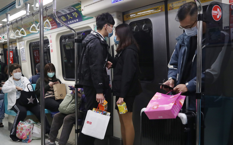 俗稱武漢肺炎的2019年冠狀病毒疾病（COVID-19）疫情持續延燒，民眾搭乘捷運都戴上口罩。(圖：中央社)