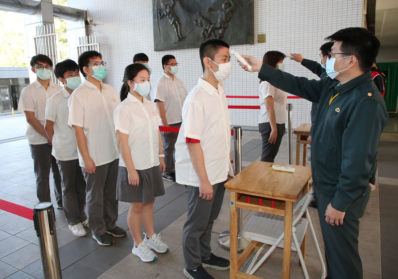COVID-19（2019年冠狀病毒疾病）疫情升溫，台北市育成高中因應25日開學在即，24日在校門口成立體溫量測站共6線，加速掌握學生身體狀況。(圖：中央社)
