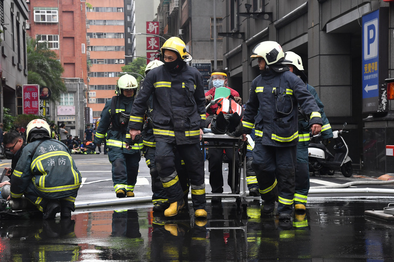 台北市林森北路錢櫃KTV26日火警，火勢約於上午11時30分撲滅，消防人員救出民眾並協助送醫。(圖: 中央社)