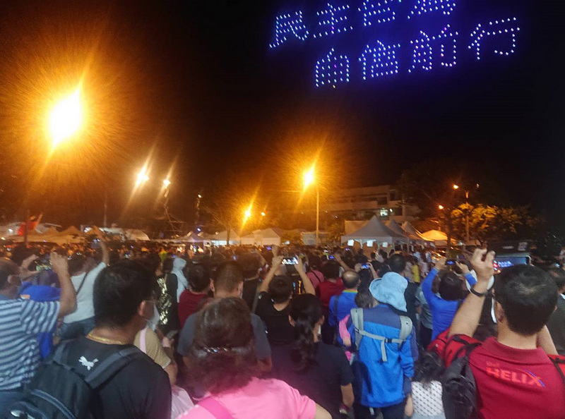 2020國慶焰火在台南，10日晚間8時將在安平漁光島施放，吸引大批民眾到活動現場等待璀璨焰火，晚間無人機先演出精彩空中排列，現場遊客搶拍留念。(圖:中央社)