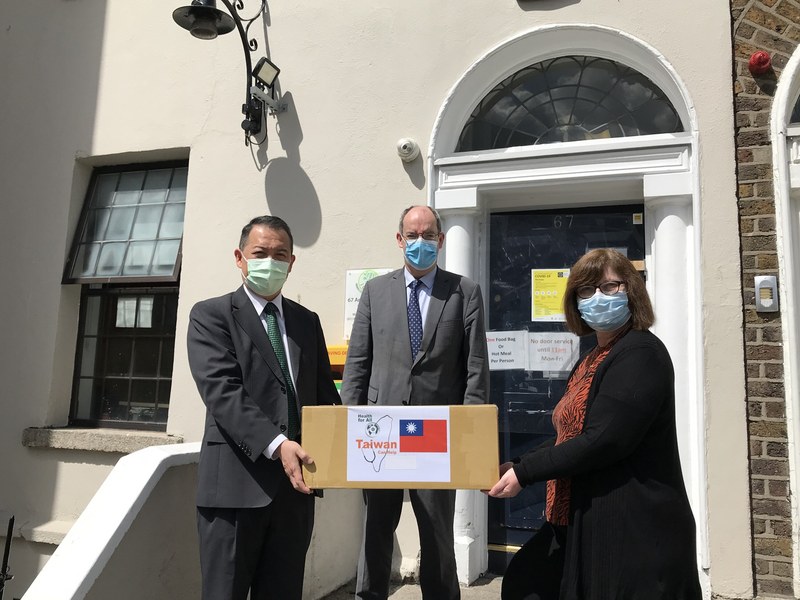 「內城無家者援助組織」董事柏尼（右）26日代表接受駐愛爾蘭代表楊子葆（左）的捐贈，愛爾蘭參議員霍爾肯（中）到場見證。（駐愛代表處提供） (圖：中央社)
