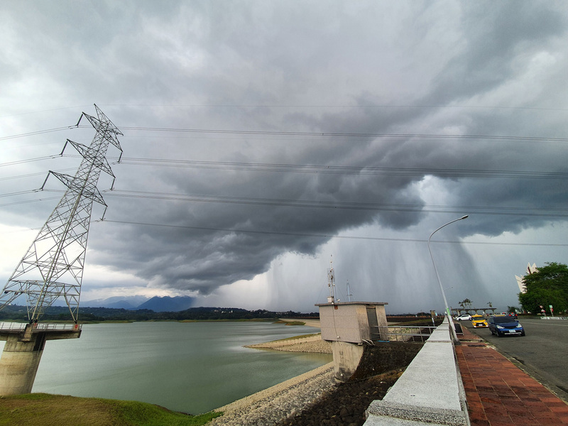 梅雨鋒面影響，嘉義縣1日持續降雨；攝影人李秋雲5月31日下午3時許在仁義潭水庫大壩拍到不遠處的「雨瀑」景觀，畫面在網路引發熱烈迴響。（李秋雲提供） (圖：中央社)