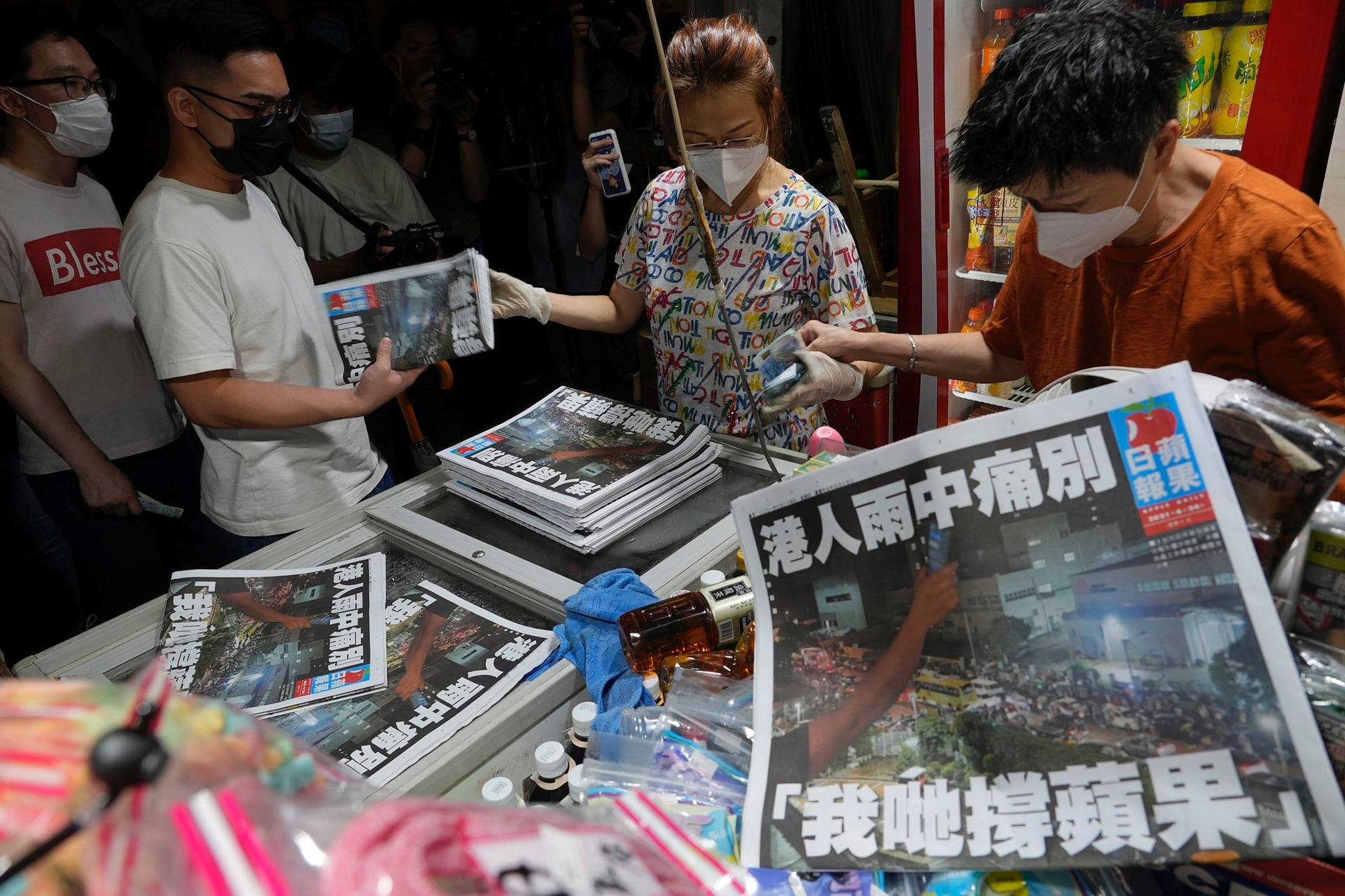 香港蘋果日報24日正式停止營運。大批香港民眾排隊購買報紙留念。(美聯社/達志影像)