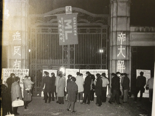 東大校門的漢字：造反有理，帝大解體。毛肖像下面是新左翼黨派的一支  「ML」派的標誌。全稱為：共產主義同盟馬列主義派。