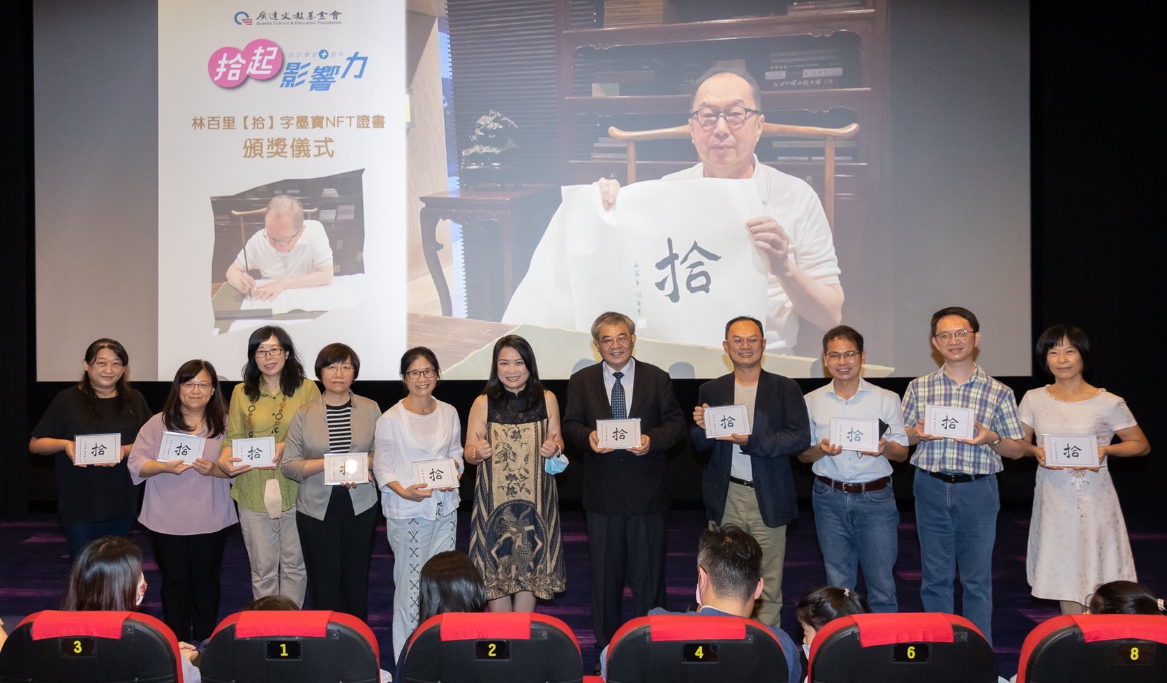 「廣達設計學習」計畫推動十年，林百里(視訊螢幕)題字做為NFT，由基金會執行長徐繪珈(左六)代為贈送給十位與會者。圖：廣達文教基金會提供