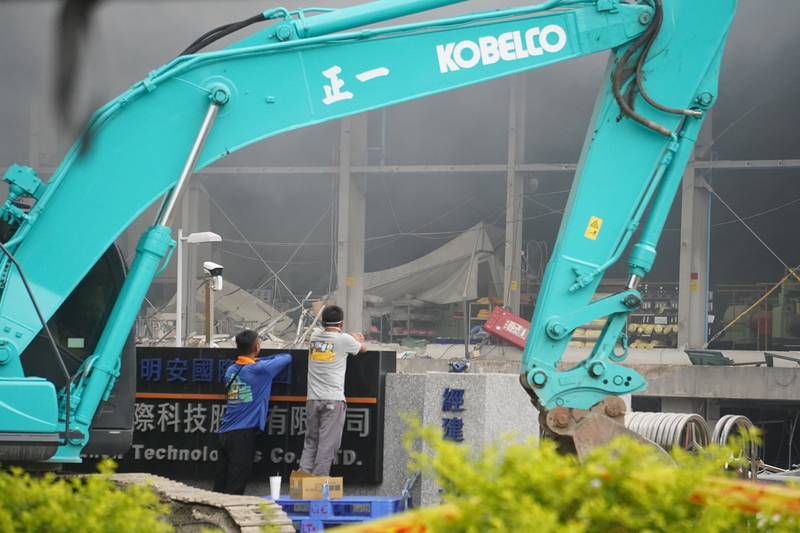 屏東科技產業園區明揚國際科技公司廠房大火爆炸釀嚴重死傷，現場23日白天仍持續悶燒，有民眾在周邊觀看毀損建物，關注搜救最新進展。 (圖：中央社)