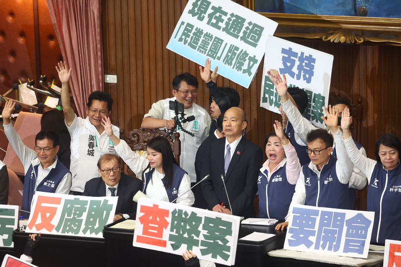 立法院會21日繼續處理藍白所提國會職權相關修法，由立法院長韓國瑜(前右4)主持，民眾黨立院黨團總召黃國昌(後左2)持手機直播表決過程，解釋議場內狀況。 (圖：中央社)