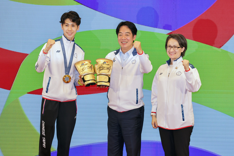 「Our Heroes！Team Taiwan 台灣英雄 榮耀同行」英雄派對16日在總統府舉行，賴清德總統(中)、副總統蕭美琴(右)一同接見巴黎奧運代表團成員，奧運金牌拳擊女將林郁婷(左)致贈金色簽名拳擊手套給賴總統。(圖：中央社)