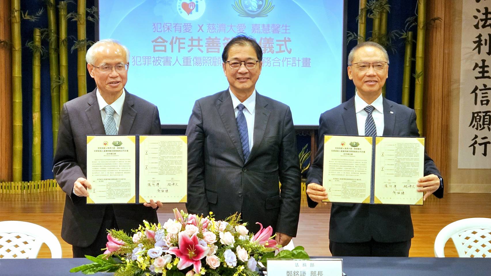 犯罪被害人保護協會董事長張斗輝(左)與慈濟基金會執行長顏博文(右)9日簽署合作備忘錄，將加強對犯罪被害人及其家屬的照顧，法務部長鄭銘謙(中)到場見證。(歐陽夢萍 攝)