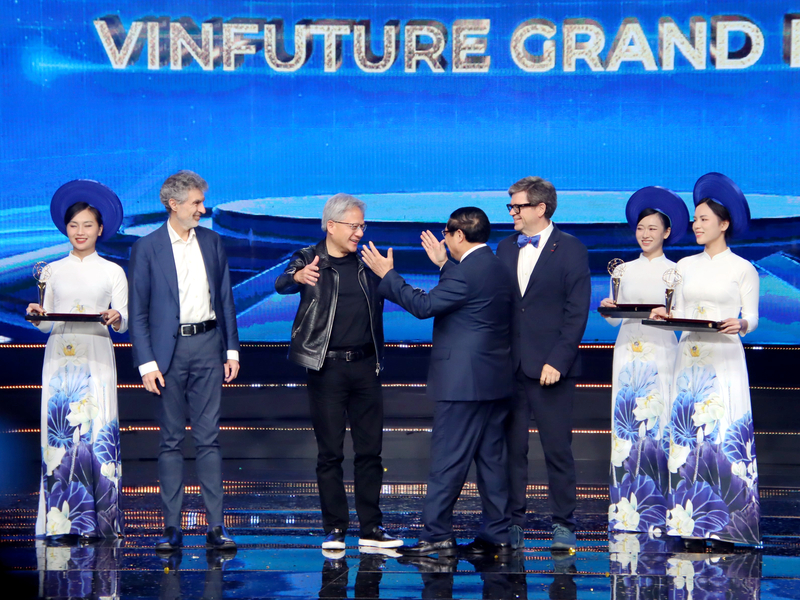 輝達創辦人暨執行長黃仁勳(左3)6日晚間拿下VinFuture Prize的主獎項，越南總理范明正(左4)上台頒獎時給黃仁勳一個擁抱。(圖：中央社)